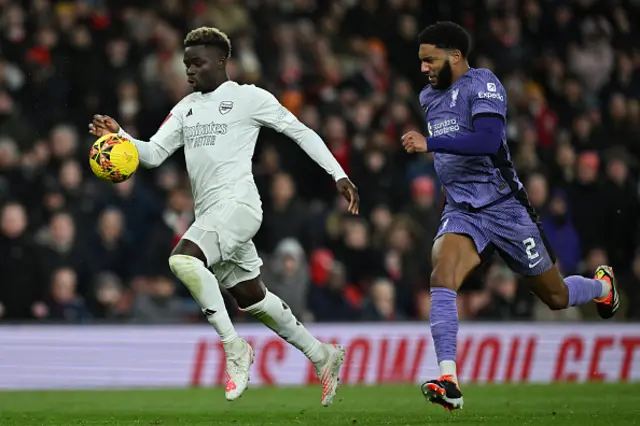 Bukayo Saka vies with Liverpool's English defender Joe Gomez