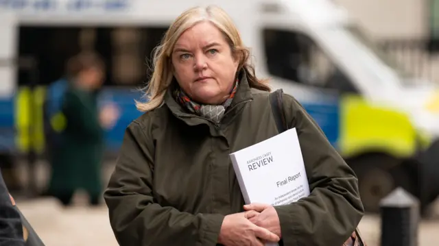 Casey holding a final copy of her review into the Met Police following the murder of Sarah Everard