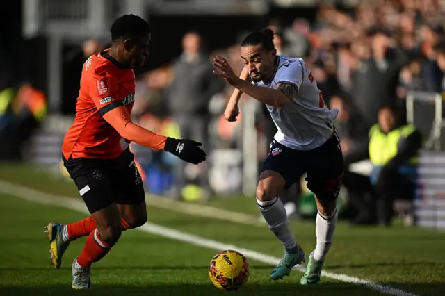 Chiedozie Ogbene vies with Bolton Wanderers' English defender Randell Williams