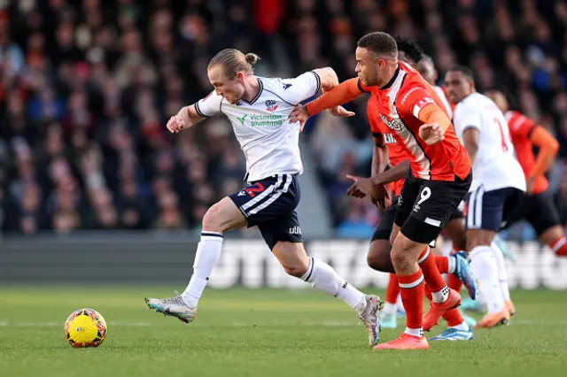 Kyle Dempsey of Bolton Wanderers runs with the ball whilst under pressure from Carlton Morris