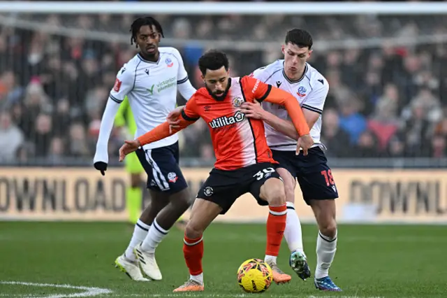 Andros Townsend vies with Bolton Wanderers' Northern Irish defender Eoin Toal