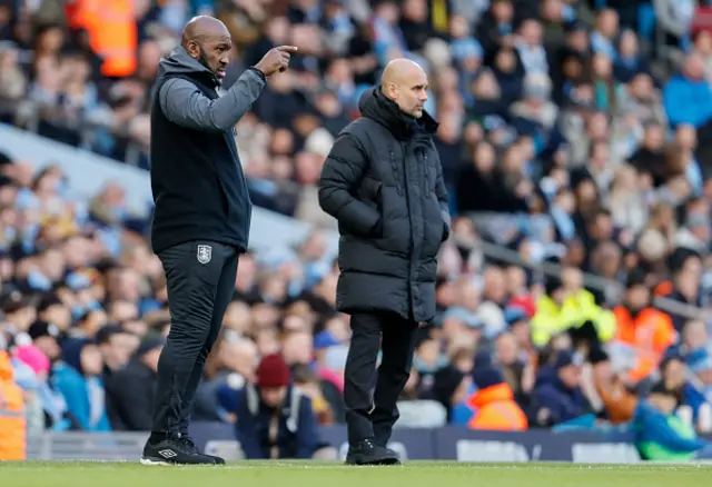 Darren Moore and Pep Guardiola look on from the touchline