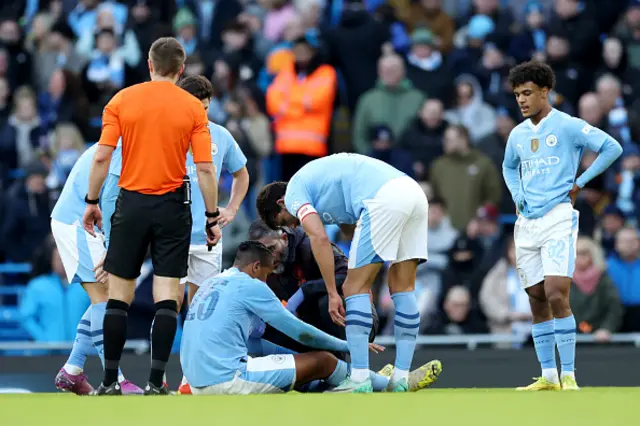 Manuel Akanji of Manchester City receives medical treatment