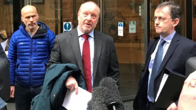 Alan Bates (centre) speaking outside London's High Court in March 2019