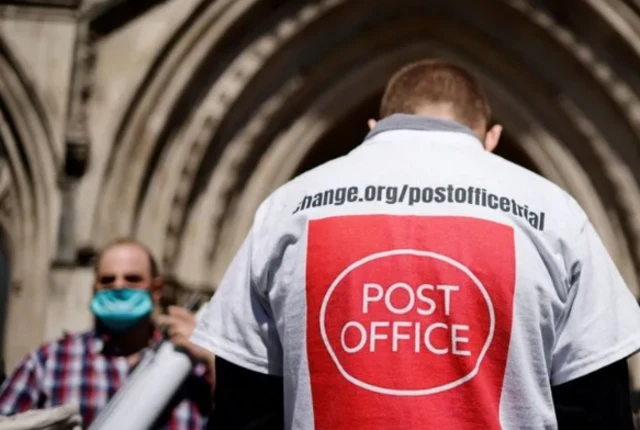 Man poses outside High Court as post masters appeal convictions