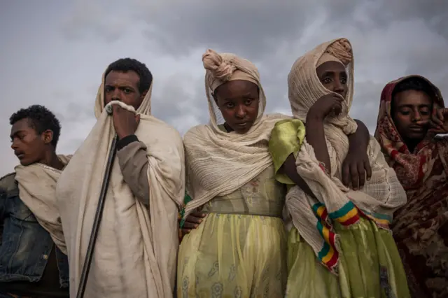 Pilgrims read prayers from bibles during the celebrations of Gena, the Ethiopian Orthodox Christmas, at Bete Mariam church in Lalibela on January 8, 2024.