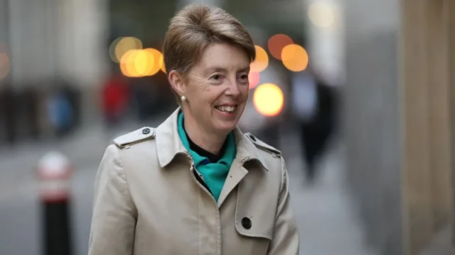 Paula Vennells walking down a street