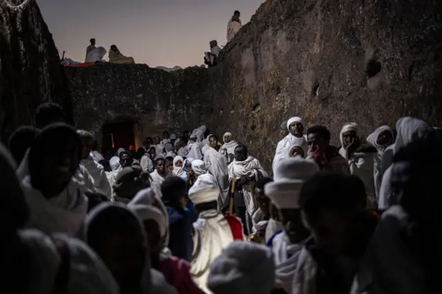 Pilgrims read prayers from bibles during the celebrations of Gena, the Ethiopian Orthodox Christmas, at Bete Mariam church in Lalibela on January 8, 2024.