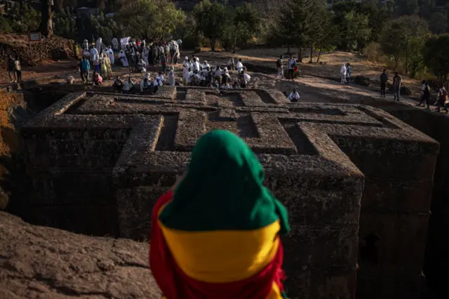 Pilgrims read prayers from bibles during the celebrations of Gena, the Ethiopian Orthodox Christmas, at Bete Mariam church in Lalibela on January 8, 2024.