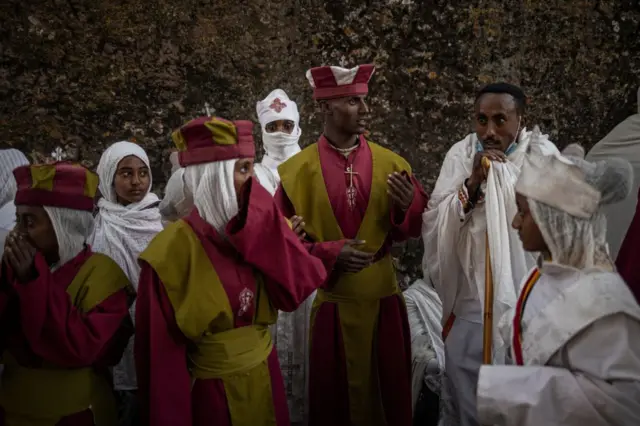 Pilgrims read prayers from bibles during the celebrations of Gena, the Ethiopian Orthodox Christmas, at Bete Mariam church in Lalibela on January 8, 2024.