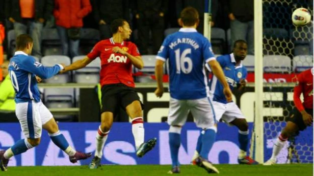 Wigan's Shaun Maloney scores against Manchester United in 2012