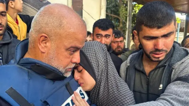 Wael al-Dahdouh hugs his daughter at the funeral of his son Hamza yesterday