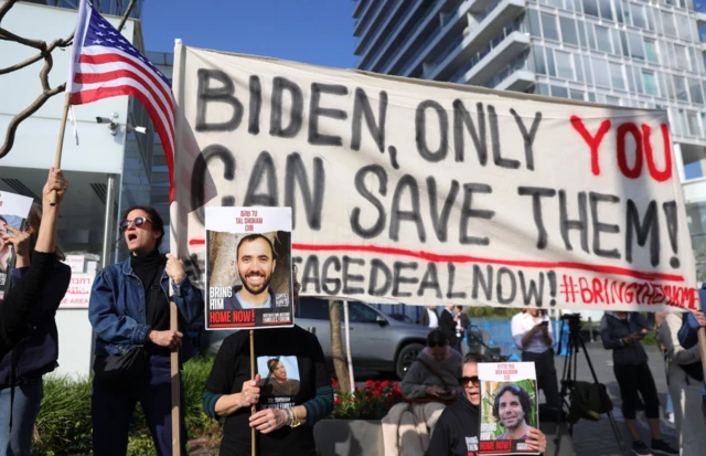 People hold up banners David Kempinski Hotel