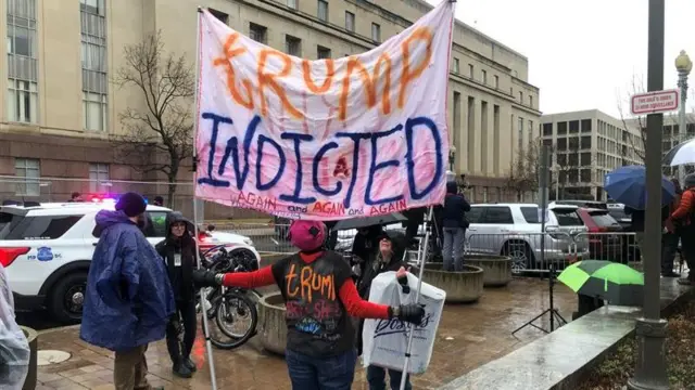 Protester holds sign on street