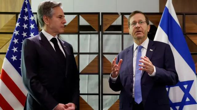 US Secretary of State Antony Blinken stands next to Israeli President Isaac Herzog