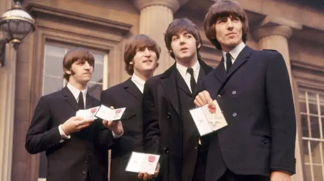 John Lennon (second left) with his MBE in 1965 - he returned it four years later