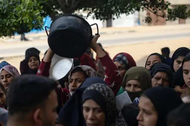 A crowd of people queuing for food in Gaza