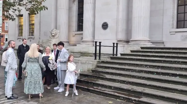 Wedding guests waiting outside Old Marylebone Town Hall