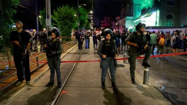 Israeli forces stand near the scene of a shooting in Jaffa, Israel