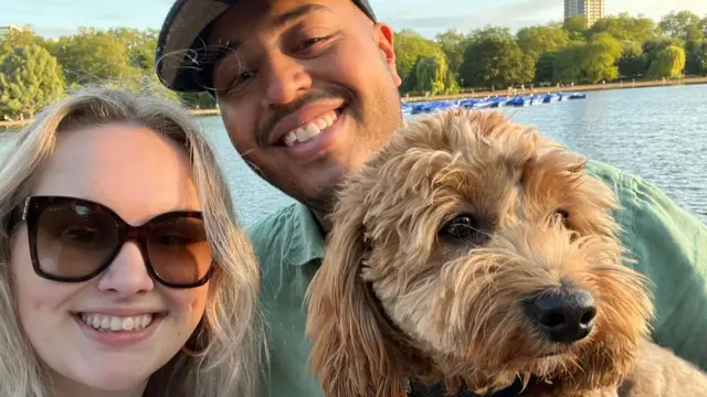 Daisy McDonnell, 27, and Dan McKinley, 27, smiling with their dog Marvin