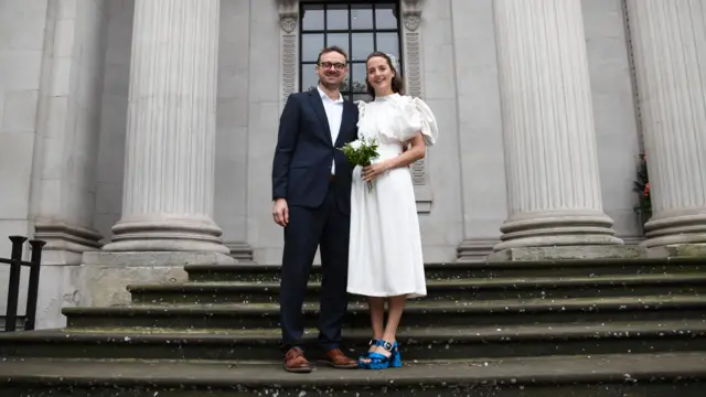 Georgina Russell and Oliver Jacques stand on the steps of the town hall