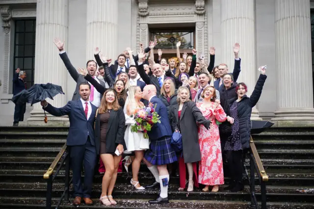 Groom Tom Mackintosh and bride Paige celebrate outside the town hall