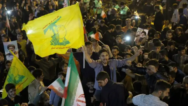 Men waving flags in celebration