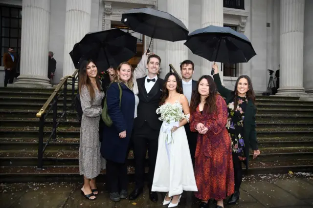 Priscilla Wong and Bradley Standfield, and guests, after getting married at Old Marylebone Town Hall,