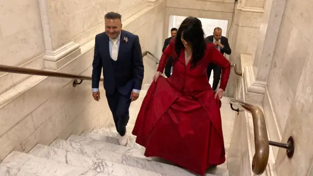 A man and woman walking up stairs