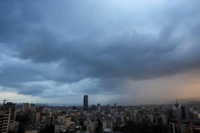 Dark clouds blanket the sky over Beirut suburbs during heavy rainfall,