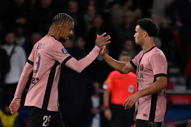 Barcola and Zaire-Emery high five to celebrate a PSG goal