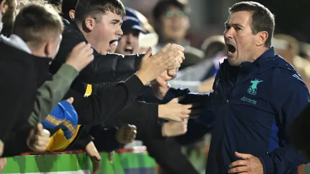 Nigel Clough celebrates a Mansfield win with supporters