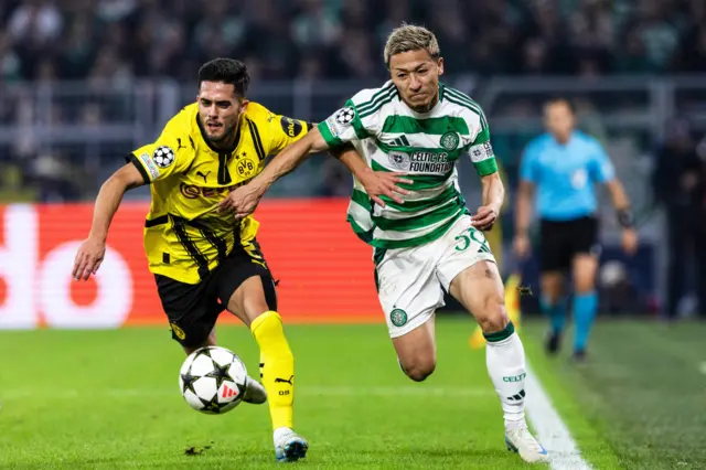 DORTMUND, GERMANY - OCTOBER 01: Celtic's Daizen Maeda and Borussia Dortmund's Yan Couto in action during a UEFA Champions League matchday two League Phase match between Borussia Dortmund and Celtic at the Signal Iduna Park, on October 01, 2024, in Dortmund, Germany. (Photo by Craig Williamson / SNS Group)