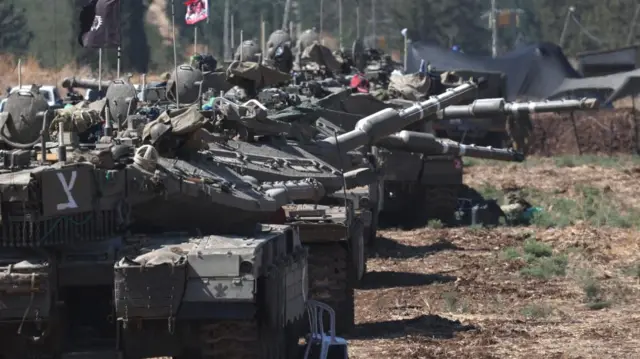 Israeli tanks assemble close to the border with Lebanon