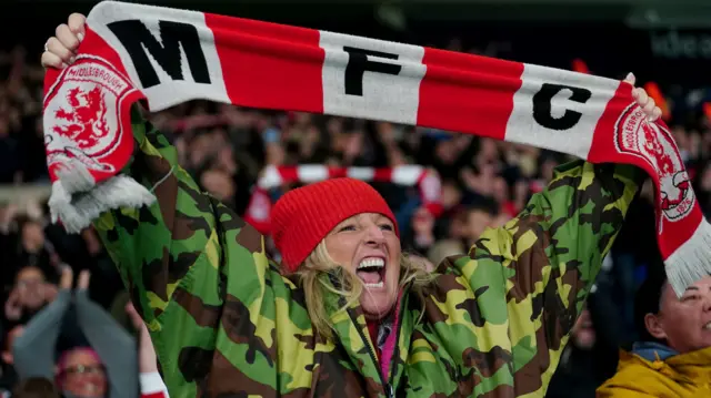 A Middlesbrough fan celebrates at full-time after their win at West Brom