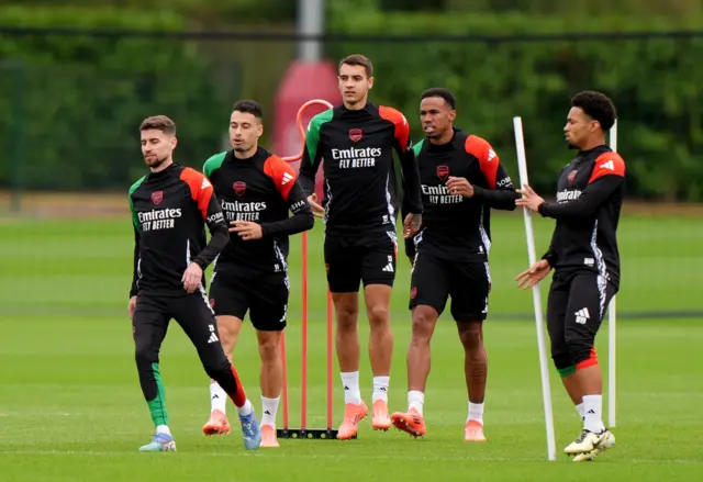 Arsenal players do a running drill in training