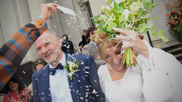 Ean Reiner and Daniela Pelusi are greeted by family and friends after getting married at Old Marylebone Town Hall