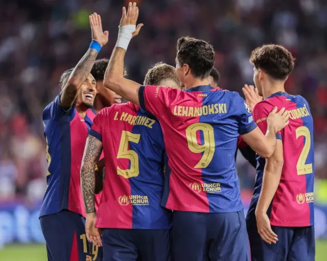 Barcelona players celebrate a goal together