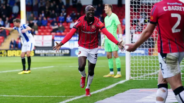 Albert Adomah celebrates a goal for Walsall