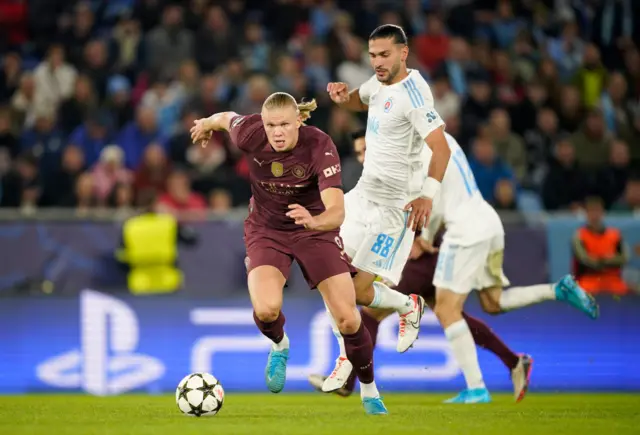 Haaland charges forward with the ball