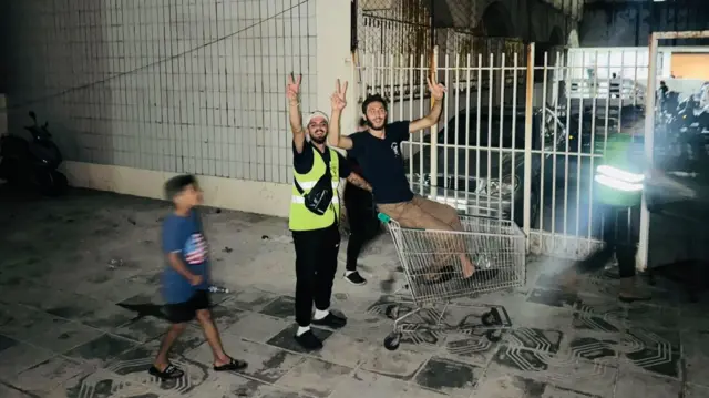 Two men holding up peace signs