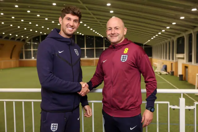 John Stones shaking hands with Lee Carsley