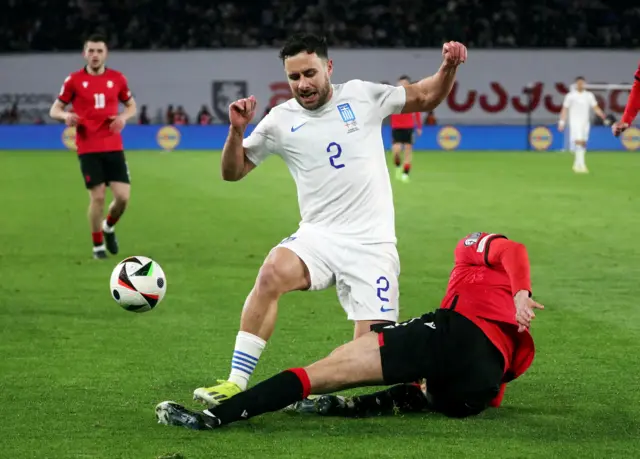 George Baldock makes a challenge while playing for Greece against Georgia