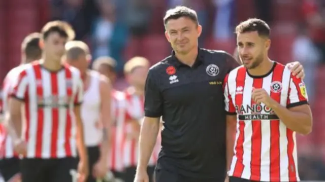 Paul Heckingbottom with his arm around George Baldock