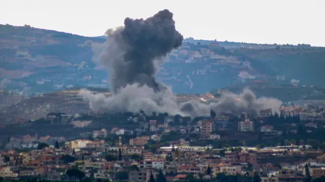 A photo taken from the southern Lebanese city of Tyre shows smoke rising from the site of an Israeli airstrike that targeted the southern village of Siddiqin on October 10, 2024