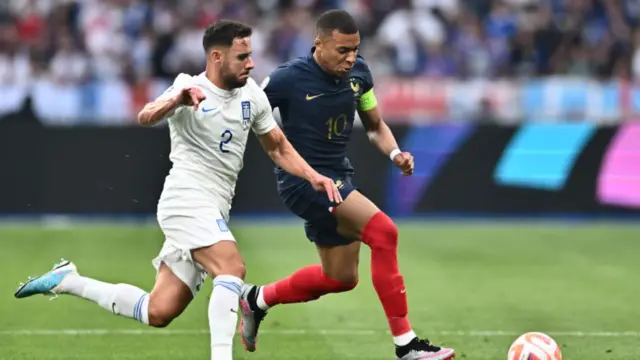 George Baldock of Greece playing against Kylian Mbappe of France in June 2023
