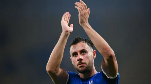 George Baldock applauds Greece fans after a Euro 2024 qualifier