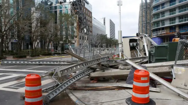 A collapsed construction crane that fell on the building that hosts the offices of the Tampa Bay Times, after Hurricane Milton made landfall