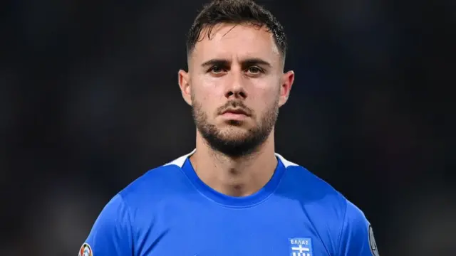 George Baldock looking straight ahead during the national anthem for Greece