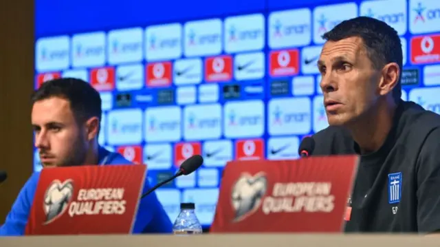 Gus Poyet and George Baldock sat at a Greece news conference